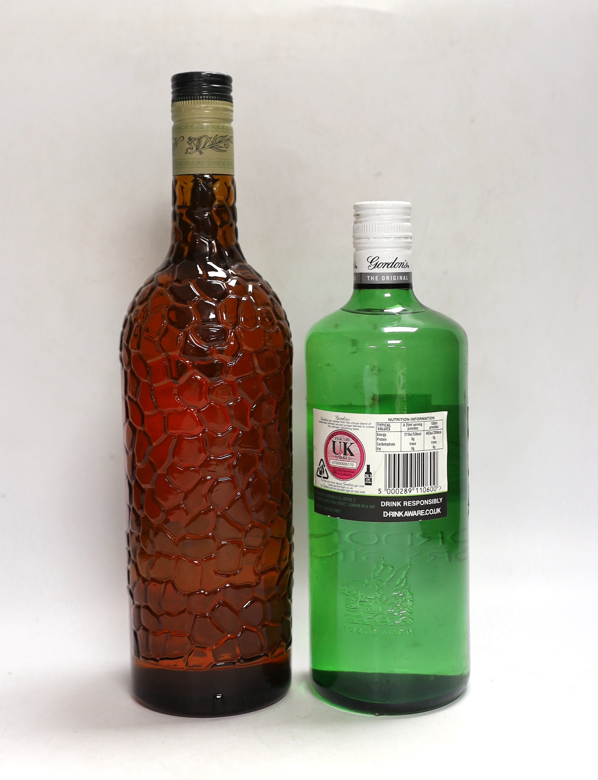 A bottle of Mandarine Napoleon brandy and a Gordon's gin